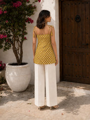 Kurti corto de algodón amarillo mostaza con nudo en los hombros y estampado floral en bloque